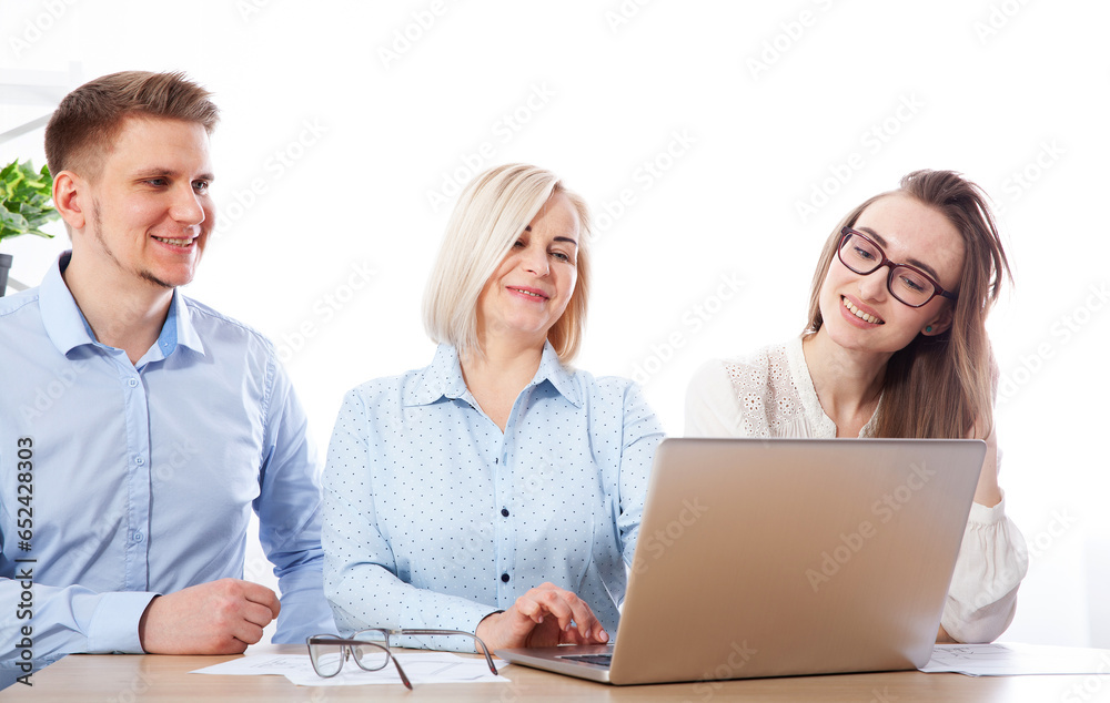 Within the office environment, a skilled businesswoman is educating and mentoring a group of young employees. Selective focus. Within the office environment, a skilled businesswoman is educating and mentoring a group of young employees. Selective focus.