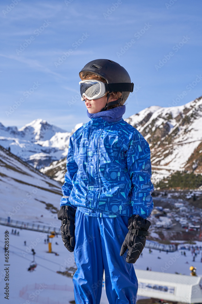 Boy looking away against ski resort