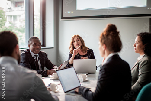 Diverse group of business people having a meeting in the conference room photo