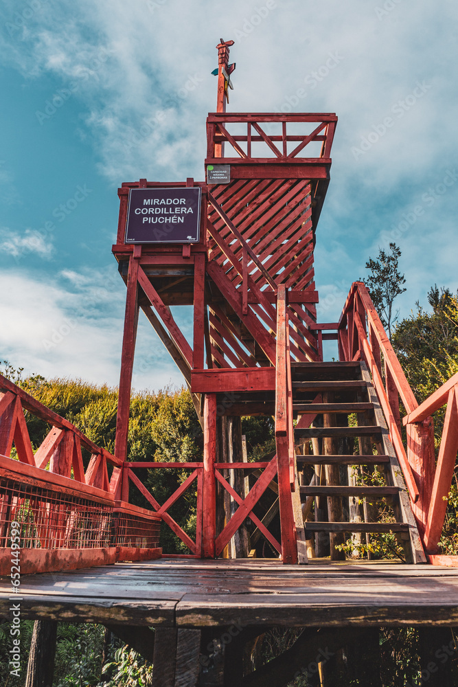 red wooden observation platform in the woods of chiloe red wooden observation platform in the woods of chiloe