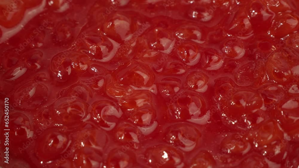 Fresh red caviar rotates. Texture of red caviar close-up. Fresh red caviar rotates. Texture of red caviar close-up.