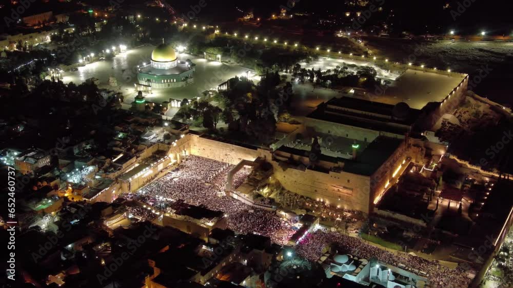 The western wall full with jewish prayers at night, spetmeber, aerial
