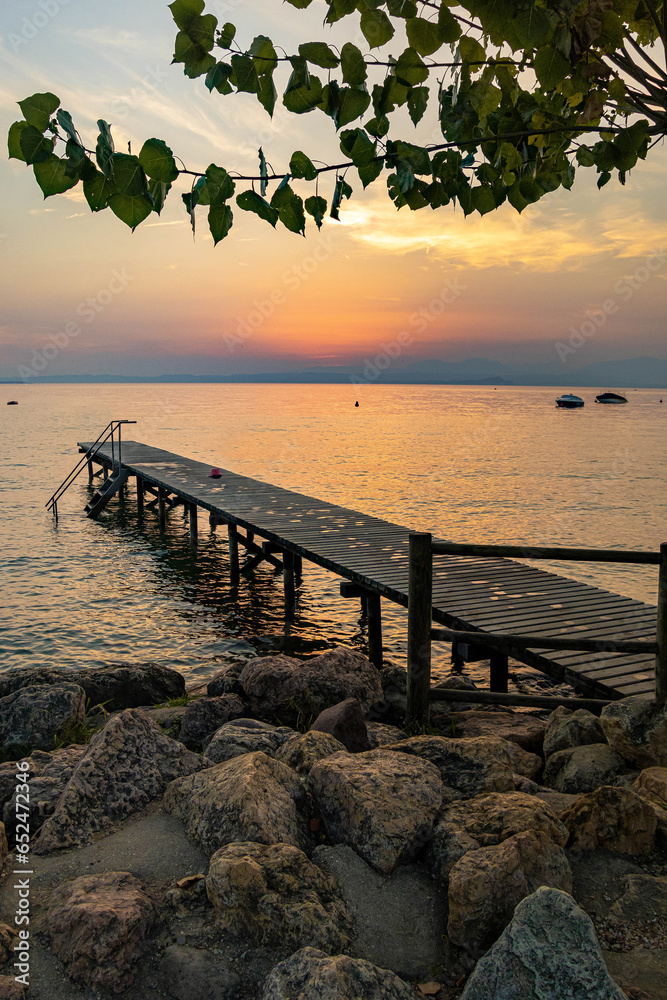 Fototapeta premium Lakeview at sunset from walkway at Cisano, Bardolino, Lake Garda, Italy
