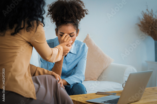 Sad PTSD woman patient in crucial therapy for mental health with psychologist, depression or grief after life failure. Frustrated trauma young woman talking to a psychologist about emotion in clinic