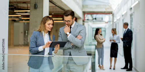 Business couple holding digital tablet and discussing company strategy © BGStock72