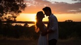 Couple sharing a kiss in front of sunset