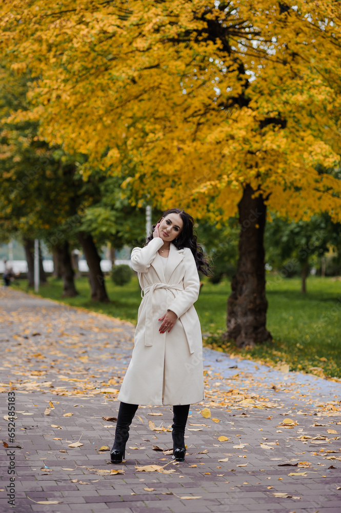 Girl in a white coat in an autumn park Girl in a white coat in an autumn park
