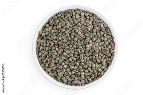raw french green lentils in ceramic bowl isolated on white background. Top view. Flat lay