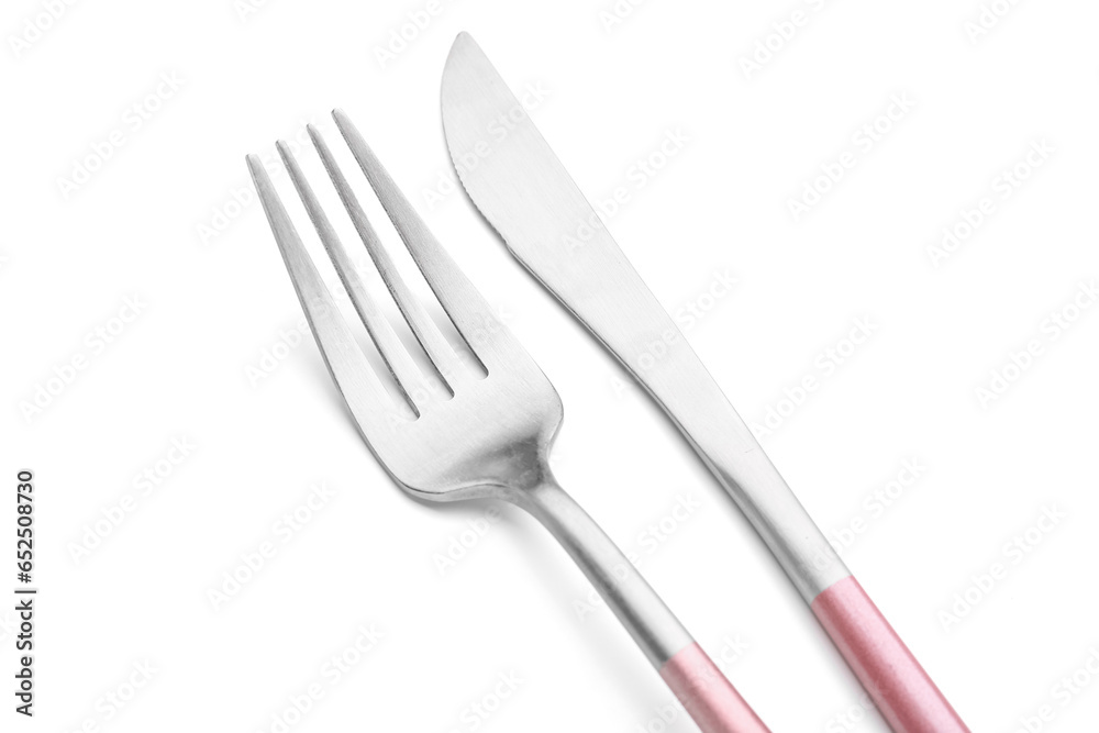 Stainless steel fork and knife with pink handles on white background Stainless steel fork and knife with pink handles on white background