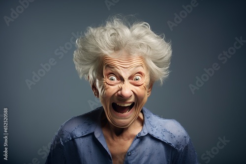 old woman squinting and grimacing in front of the camera in the studio © Jorge Ferreiro