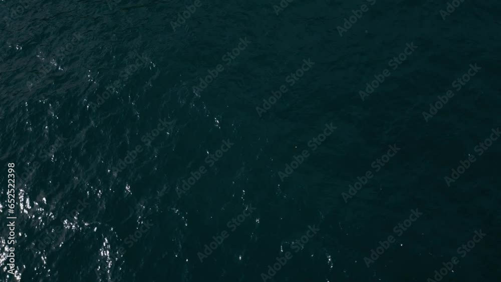 A flying drone video from above the sea surface allows you to appreciate the beauty of endless waters and the dance of waves. A flying drone video from above the sea surface allows you to appreciate the beauty of endless waters and the dance of waves.