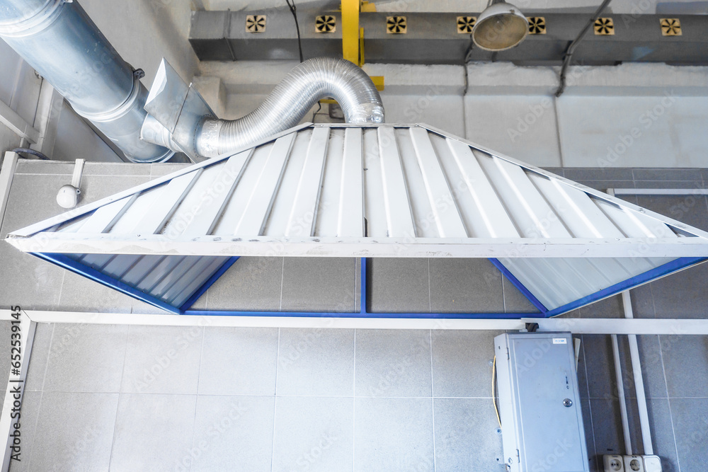 Naklejka premium Industrial hood in production workshop. Room ventilation system. Background.
