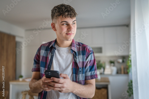 One man caucasian male teenager boy use mobile phone smartphone sms