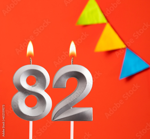 Birthday candle number 82 - Invitation card in orange background