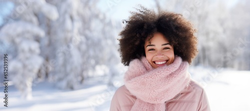 Happy Young African American Woman in a Pink Scarf in the Snow with Space for Copy