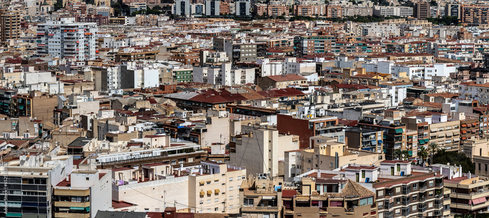 Cityscape of Alicante in summer, Spain. Large panorama of old city. Towers and roofs of the city tiled roofs high resolution panorama of roofs of old city for design print with