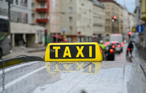 Taxi sign on car roof. Cab on the street. Taxi stand in the city. Transportation. 