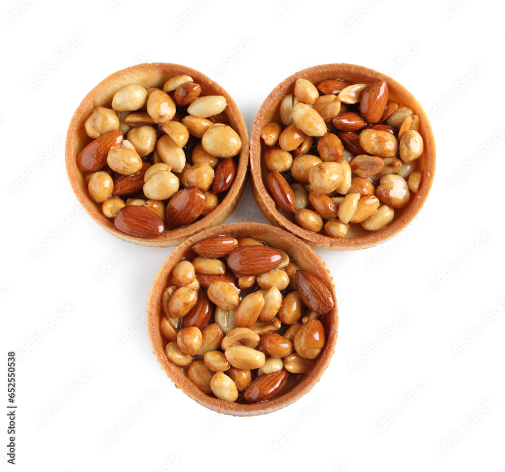 Tartlets with caramelized nuts isolated on white, top view. Tasty dessert Tartlets with caramelized nuts isolated on white, top view. Tasty dessert