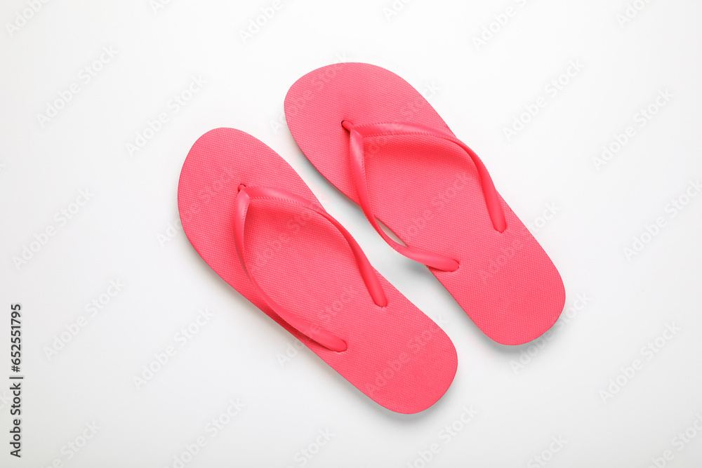 Stylish pink flip flops on white background, top view Stylish pink flip flops on white background, top view