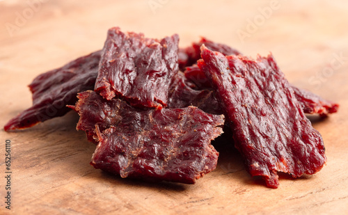 Pile of Kippered Beef Steak Beef Jerky on a Rustic Wooden Table