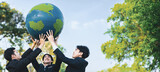 Earth day concept with big Earth globe held by group of asian business people team promoting environmental awareness with environmentally sustainability and ESG principle for brighter future. Gyre