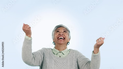 Woman, hands and catch in studio with excited face for money, winner prize or lottery on blue background. Senior, person and grab falling bonus with happiness for cash opportunity or achievement