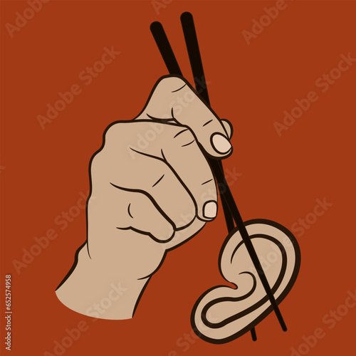 Human hand holding a human ear with chopsticks. Creative design. Cannibalism or gossip. 