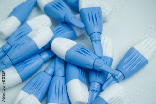 pile of blue lancets isolated on white background photo