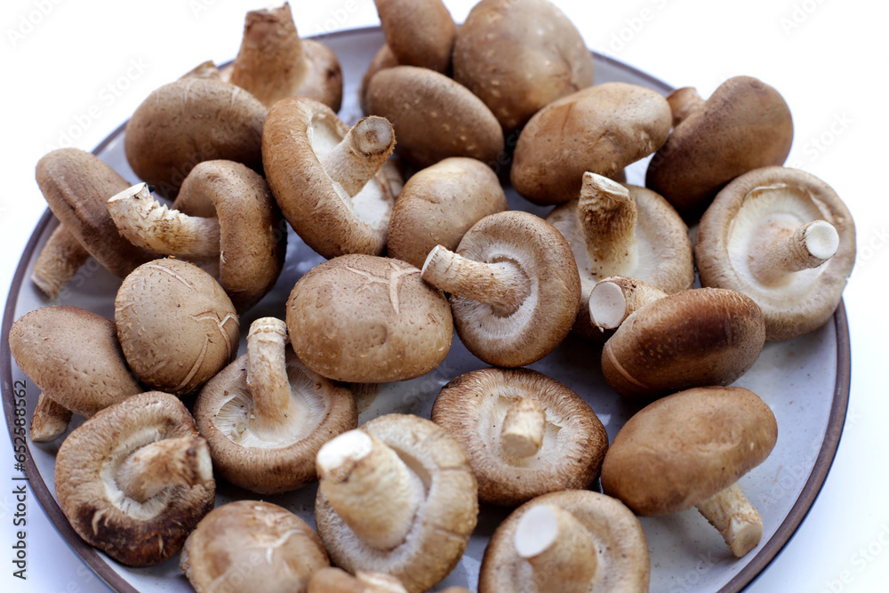 Fresh shiitake mushrooms on white background. Fresh shiitake mushrooms on white background.