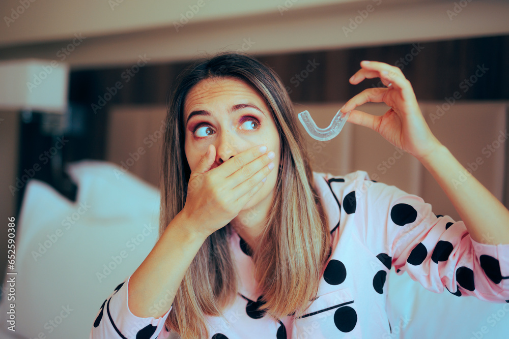 Woman Taking out her Teeth Aligner Before Going to Sleep. Girl