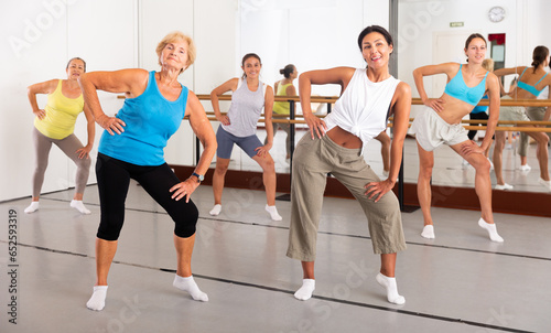 Active women who care about their health are engaged in energetic dancing in group classes in the studio