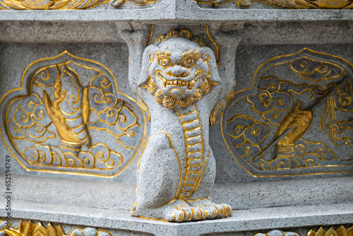 Stone dragon statue with golden colored ornaments in Daci buddhist temple, Chengdu, Sichuan province, China