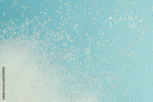 salt on light blue background, top view.