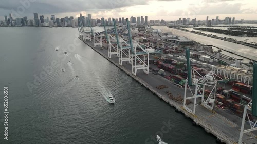 Miami commercial port south beach downtown skyline cityscape at sunset drone fly above crane cargo container boat photo