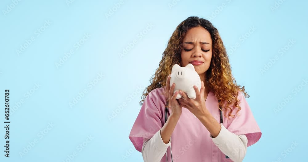 Nurse woman, piggy bank and money in studio, listen or check with mockup space by blue background. Doctor, saving and idea with question, why and doubt on face for cash, investment or plan for future Nurse woman, piggy bank and money in studio, listen or check with mockup space by blue background. Doctor, saving and idea with question, why and doubt on face for cash, investment or plan for future