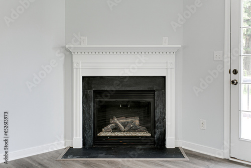 Fall Modern White Fireplace Mantle with Electric Stacked Logs and Minimal Grey Engineered Flooring with Copyspace