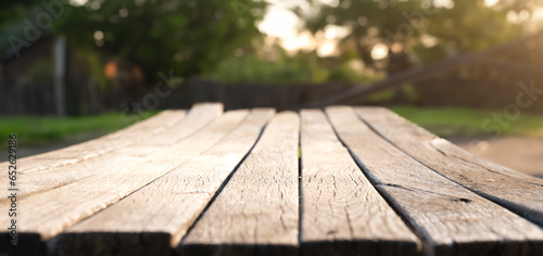 Wooden board empty table in front of blurred background. Perspective brown wood over blur trees in forest - can be used mock up for display or montage your products. . High quality photo