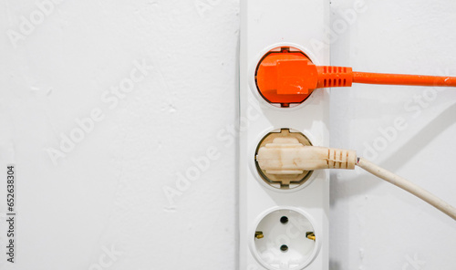 electrical outlet on a wall, electrical power switch, electric plug on a wall, orange electrical plug photo