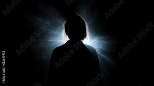 Faint white aura glow around silouette of a person simple dark background