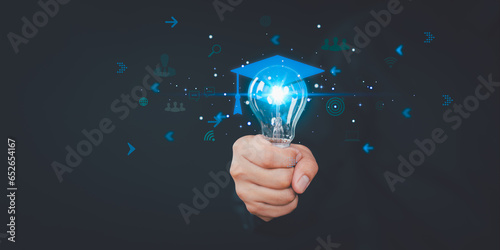 Hand showing graduation hat icon in light bulb. Internet education course degree and study knowledge. Creative thinking idea with goal, laptop, friend. E-learning graduate certificate program concept.