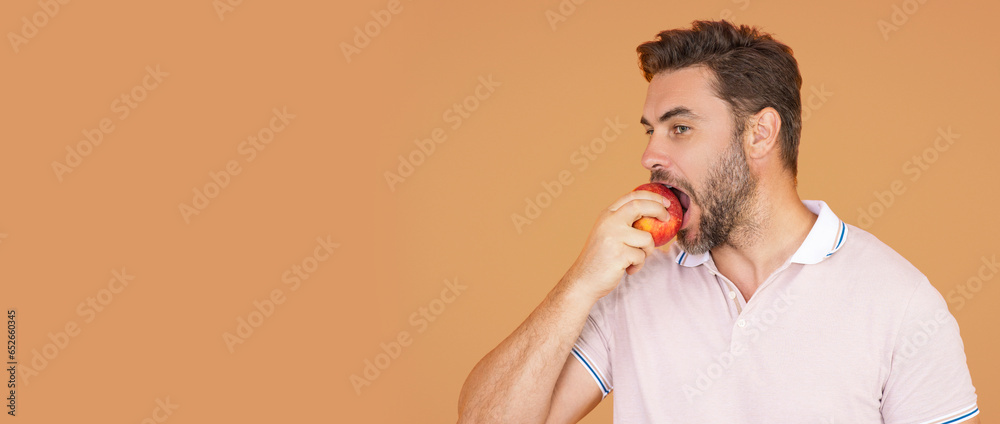 People with apple. Portrait of man eating apple isolated over studio background. Healthy apple fruit for natural vitamin dieting and healthy lifestyle. Studio portrait of hispanic man eat green apple.