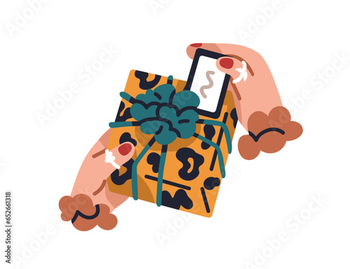 Gift box in hands. Receiving birthday present packed in festive paper wrappin...