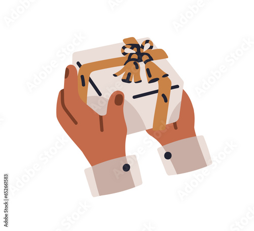 Hands holding gift box. Presenting, receiving holiday surprise wrapped in fes...