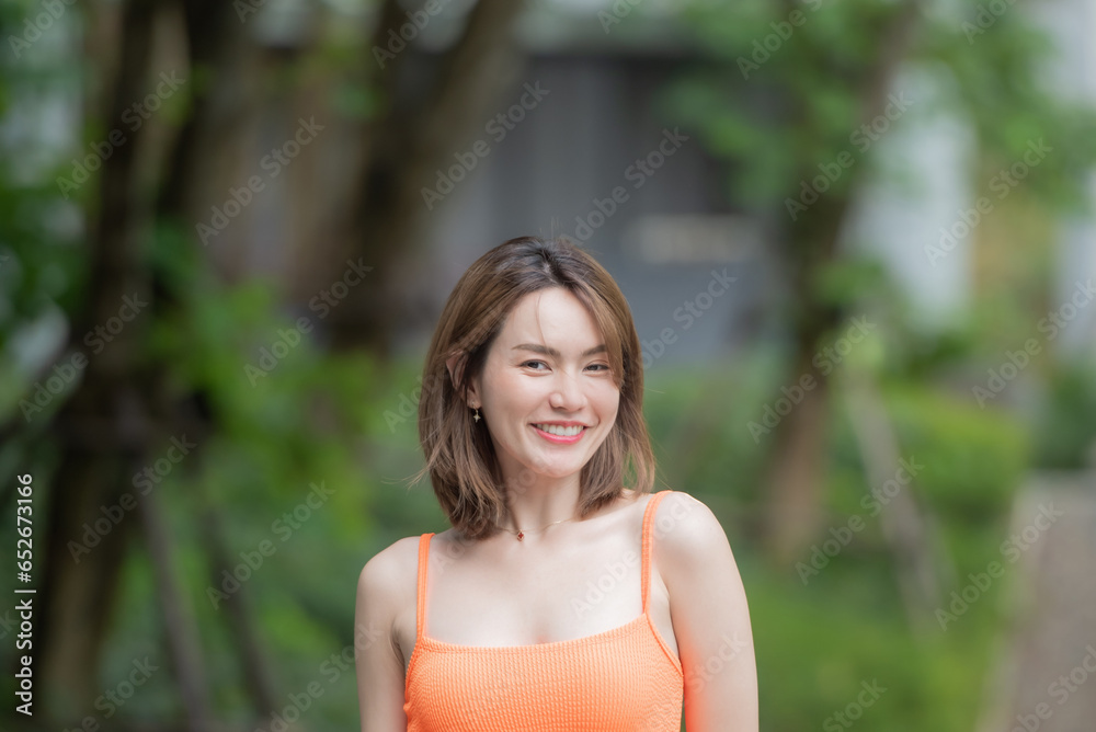 Portrait of young smiling woman looking at camera. happy girl standing in creative office. casual smiling laughing lifestyle of single female, natural look healthy skin and perfect teeth. Portrait of young smiling woman looking at camera. happy girl standing in creative office. casual smiling laughing lifestyle of single female, natural look healthy skin and perfect teeth.