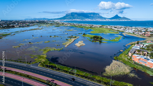 Widespread storm flooding in Cape Town, South Africa, after an exceptionally strong winter storm. Drone view, Table Mountain in background. 