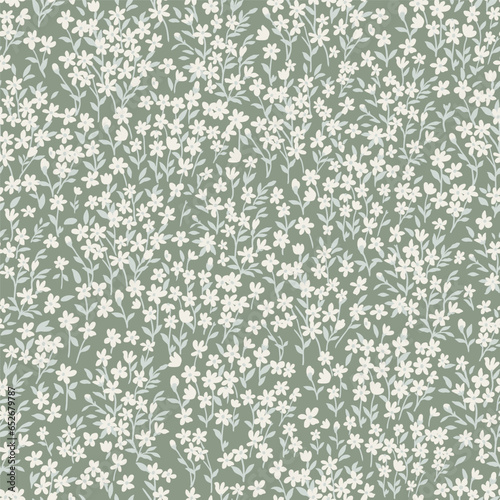 Seamless pattern with simple white flowers and light green leaves on long stems. Cute spring floral print with painted small flowers and leaves on a light green background.