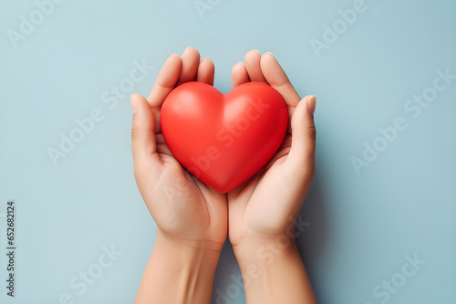 Top view showing woman's hands gently holding a heart. Generative AI.
