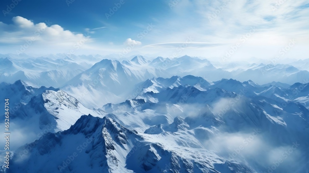 Breathtaking aerial view: snow-capped mountain peaks, rugged wilderness