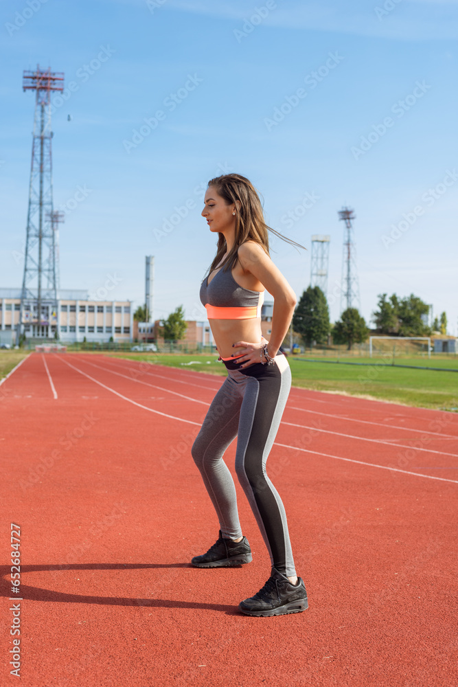 Beautiful woman training on the tracks on a sunny morning
