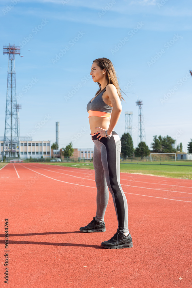 Beautiful woman training on the tracks on a sunny morning